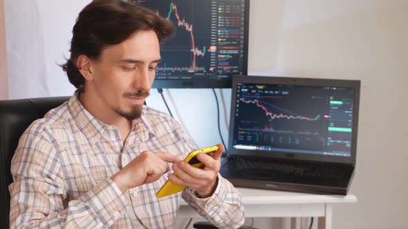 Handsome Man Against Background of Screens and Computers Cryptocurrency Graphics Bitcoin and