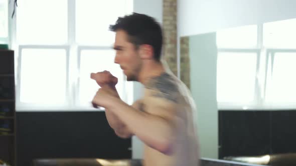 Handsome Muscular Male Boxer Working Out at the Gym, Practicing Punches 1080p alt