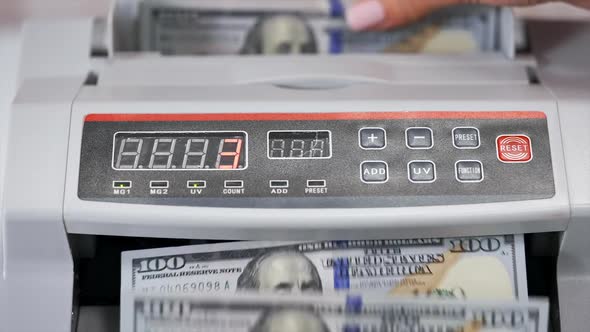 Money counting equipment for paper money calculation. US national paper currency.  alt