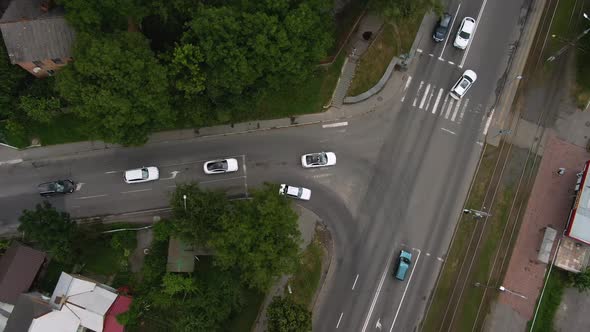 Top View Tracking From a Height of a Cortege of White Cars Traveling on the Road of the City