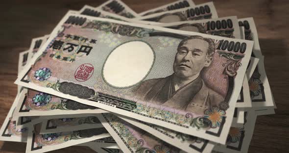 Yen 10000 money banknotes falling on the table alt