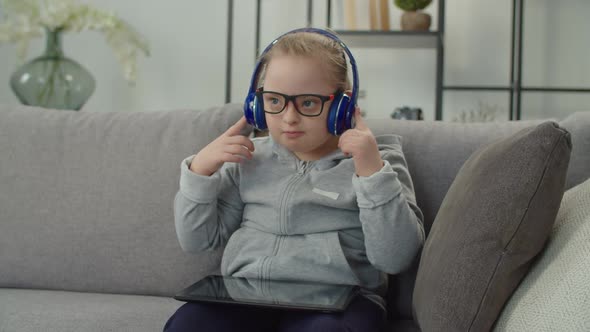 Girl with Down Syndrome Engaged in Online Education at Home alt