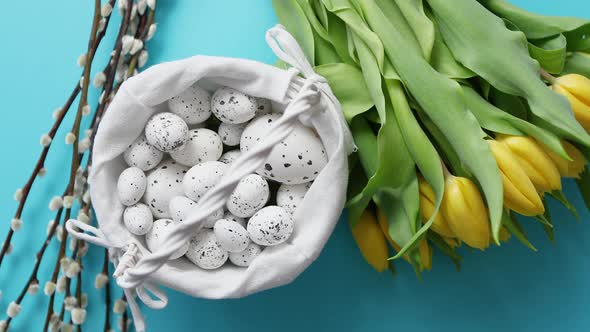 Holiday Contept Decoration with Easter Eggs and Yellow Tulips Over Blue alt