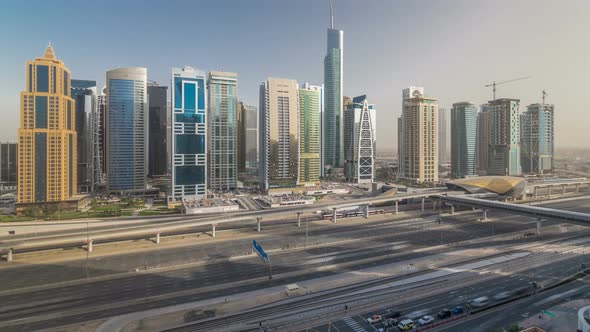 Aerial View of Jumeirah Lakes Towers Skyscrapers Timelapse with Traffic on Sheikh Zayed Road alt