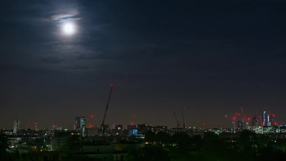 View of the Skyline of London with Buildings from Primrose Hill under a Full Moon alt