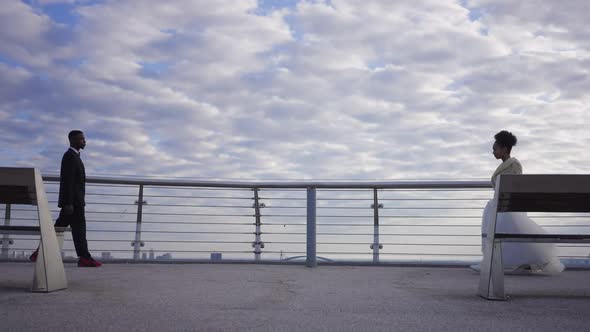 Wide Shot of Loving Bride and Groom Meeting on Bridge Outdoors alt