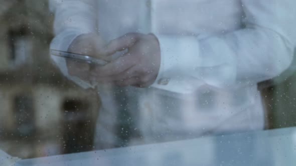 Depressed Divorced Man Texting From Smartphone, Rain Dropping on Window Glass alt