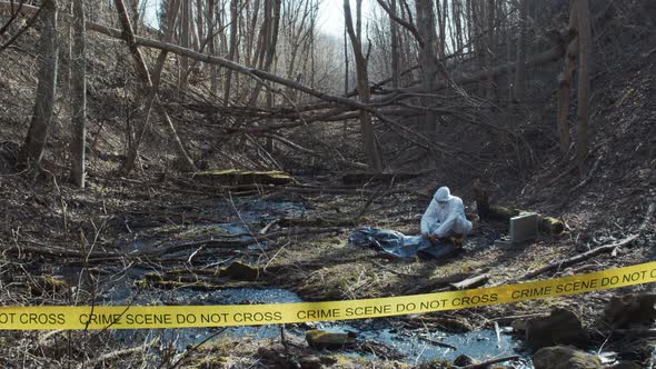Forensic specialists working in the forest. Crime scene and police concept. alt