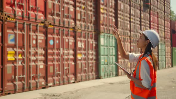 Asian engineer Foreman female worker working checking at Container cargo alt
