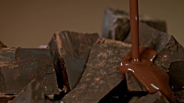 Super Slow Motion Shot of Pouring Melted Chocolate on Raw Chocolate Chunks at 1000 Fps alt