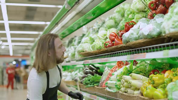 Man Replenishes Products on the Shelves Young Man Puts Paprika on a Shelf in an Organic Store Works alt