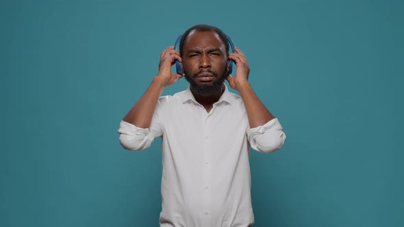 Cool Happy Man Listening to Stereo Music on Audio Headset alt