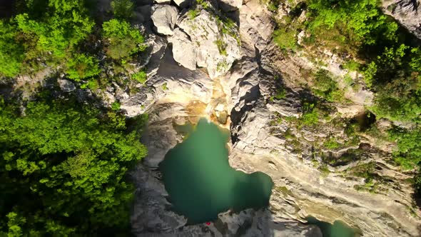 aerial drone headshot of Albanian canyon "Syri i ciklopit". Albanian nature stock videos. alt