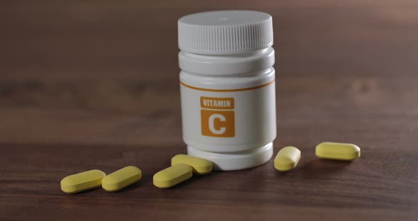 Yellow Vitamin C Pills on a Table alt