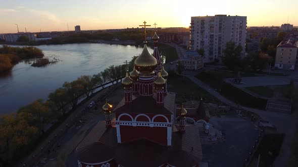 Aerial Drone Shot the Church on a Sunny Sunset on the Background of the Great alt