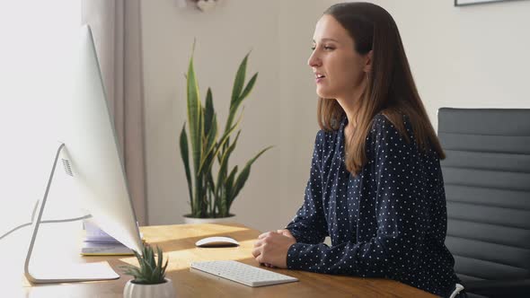 Young Positive Businesswoman Using Computer for Video Communication alt