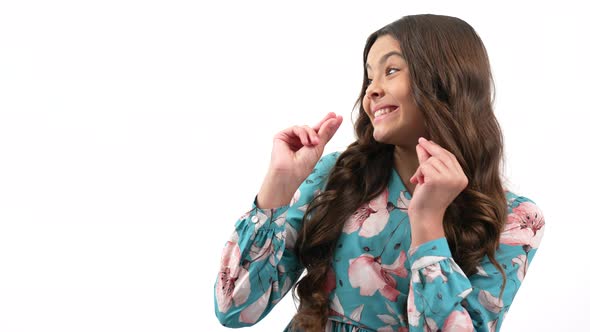 Amazed Happy Teen Girl with Curly Hair Pointing Finger on Copy Space for Advertising Advertisement