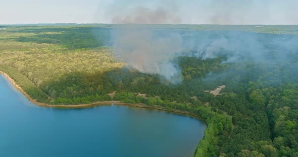 Aerial View a Smoke Coming From a Trees on Fire in the Forest alt