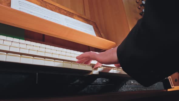 Organist Plays Music on Church Organ