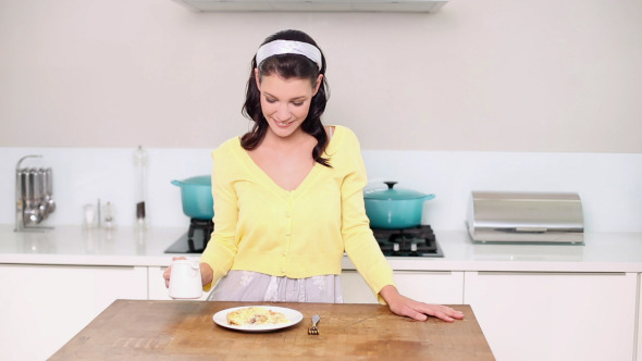 Beautiful Brunette Pouring Cream Onto A Dessert alt
