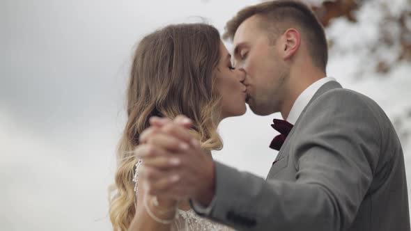 Lovely Caucasian Wedding Newlyweds Family Bride Groom Holding Hands Making a Kiss on Mountain Slope alt