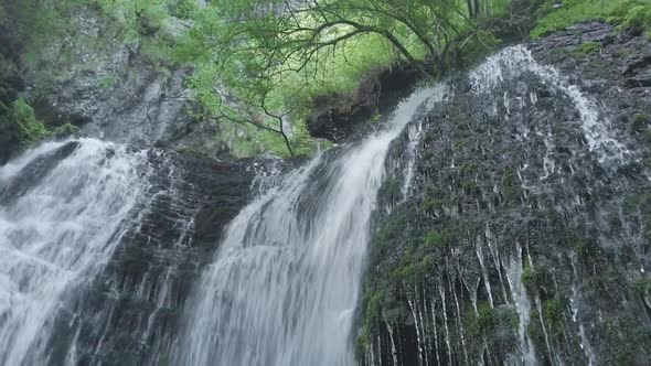 Jumping With Waterfall Into A Stream alt