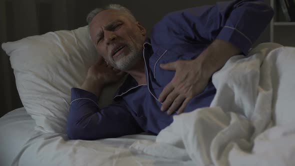 Senior Man Having Heart Attack, Suffering Sharp Chest Pain While Sleeping alt
