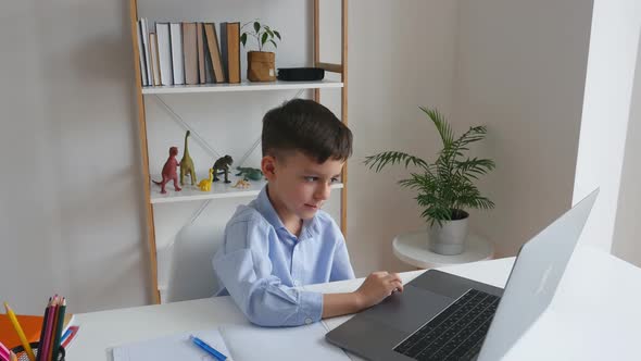 Kid Via Laptop Talking with Teacher During Online Studying at Home