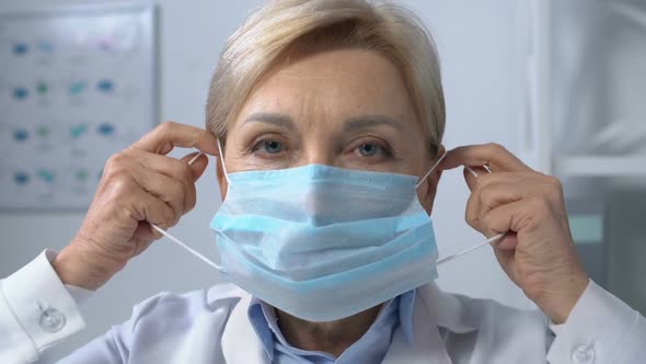 Experienced Doctor Putting on Protective Mask, Viral Disease Risk, Patient POV