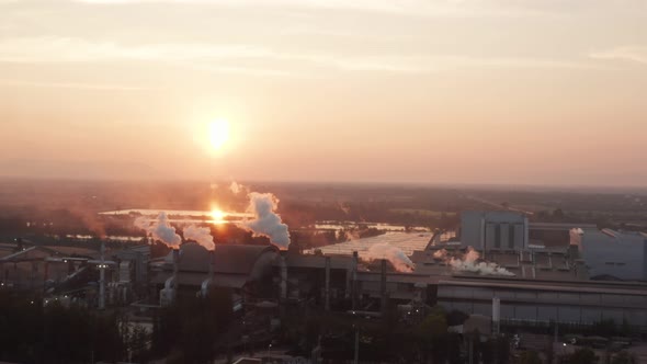 Aerial view Drone shot of flying around toxic chimneys tubing. Air Pollutants, Industrial zone