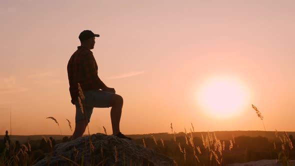 Pensive Man On Top Of A Mountain At Sunset. Dreamy, Looking Into The Distance