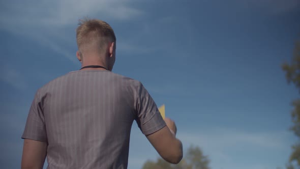 Soccer Referee Indicating Yellow Card To Player alt