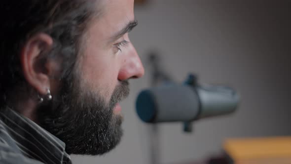 Young Bearded Man Talking in a Videoconference and Smiling alt