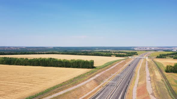 Aerial photography of agricultural fields in Russia. Beautiful views. Highway along the fields.