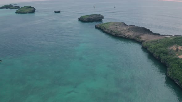 Fishing boats in Watamu Bay Beach at sunrise near Malindi, Kenya. Aerial drone reveal alt