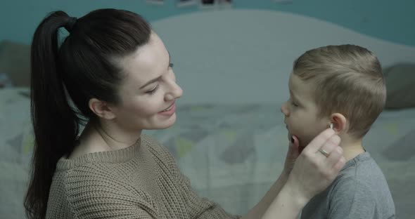 Cleaning Ears With A Cotton Swab A Parent Taking Care Of Her Child alt