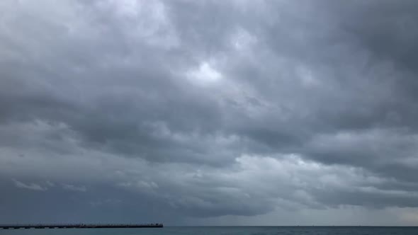 Heavy Rain Clouds Above Sea Timelapse alt