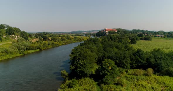 Aerial Beautiful View Landscape of City and River and Church on a Small Hill. alt