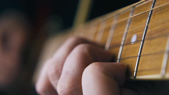 Person Plays Guitar Striking Chord and Moving Little Finger alt
