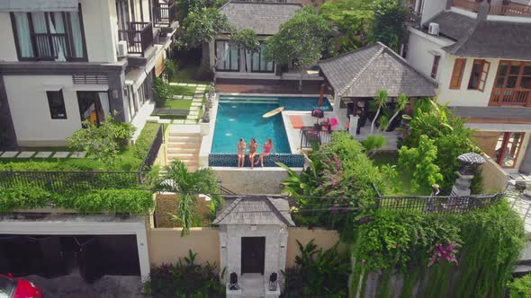 Flight Overlooking the Villa and Girls Near Uluwatu Town on Bali Island Indonesia alt