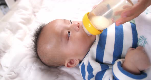 baby drinking milk from bottle