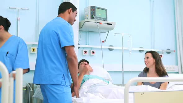 Patient holding the hands of his wife alt