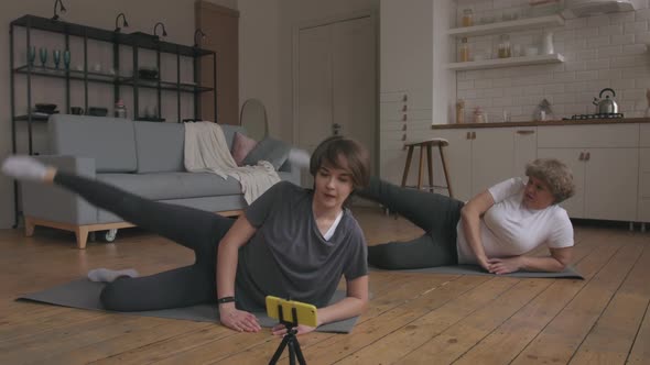 Mom and Daughter Doing the Home Fitness Exercises. alt