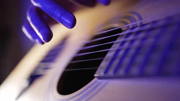 Hand of Man Touching Strings of Guitar Performing on Stage alt