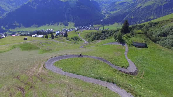 Aerial view of a mountain biker on a scenic singletrack trail. alt