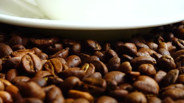 Cup with coffee on the background of coffee beans. alt