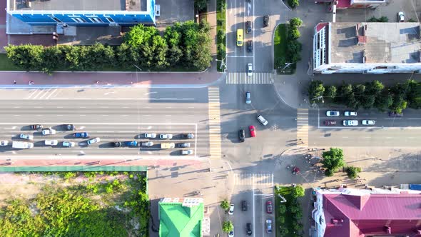 Cross roads, trees, cars during the golden hour at summer sunset. Drone footage alt