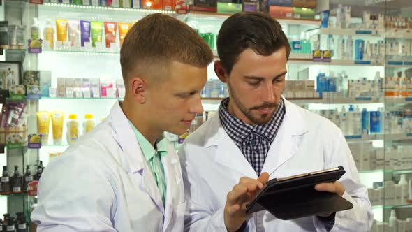 Two Druggists Using a Tablet at Work