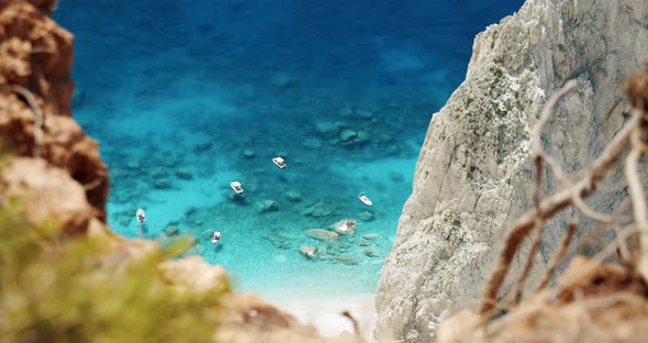 Tourest Pleasure Boats in Blue Sea Lagoon Framed By Nature Arid Dry Ground Greece alt