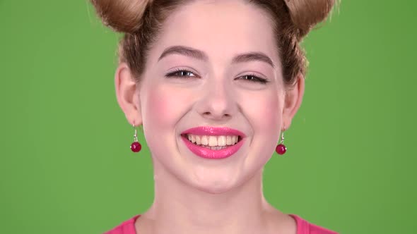 Girl Looks at the Phone and Is Surprised at What She Saw, Shows a Thumbs Up. Green Screen. Close Up alt